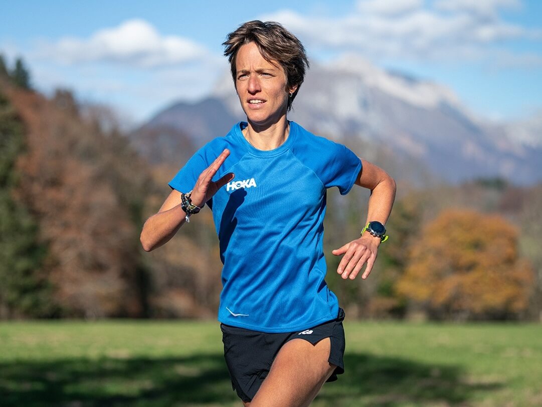 Audrey wearing HOKA shirt in blue running
