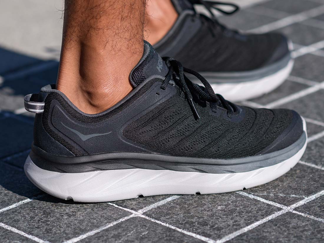 A man standing in HOKA shoes
