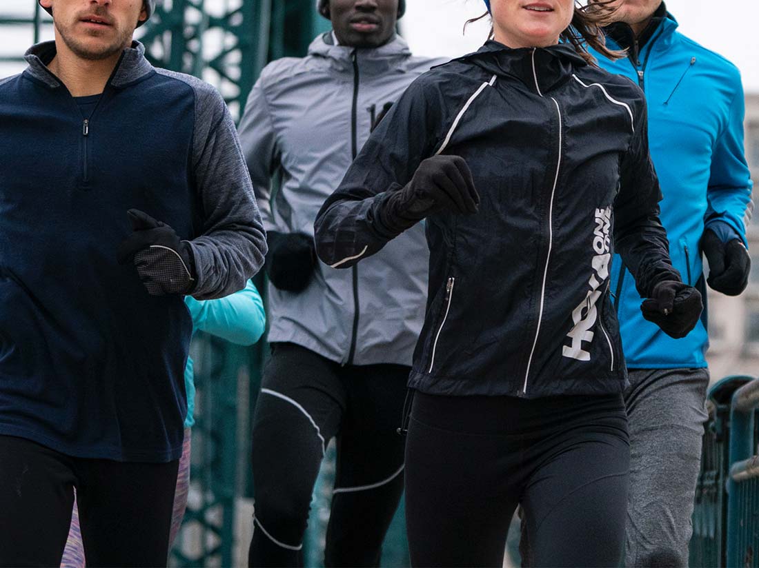 three people running down a road