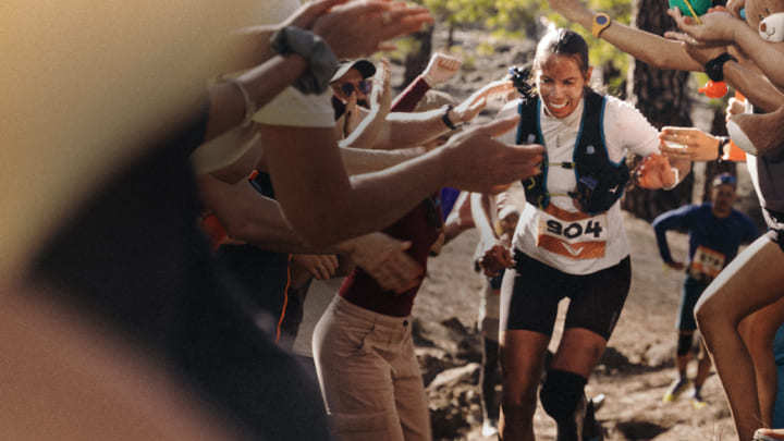 Un coureur traversant une foule de spectateurs en liesse